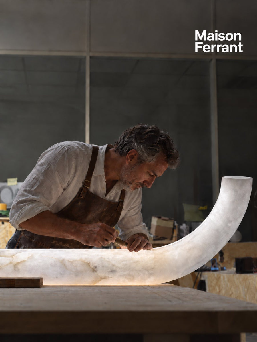 Un artisan sculpte une lampe en albâtre dans son atelier
